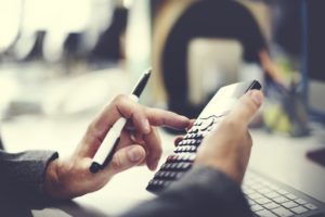 Picture of immigration attorney using a calculator